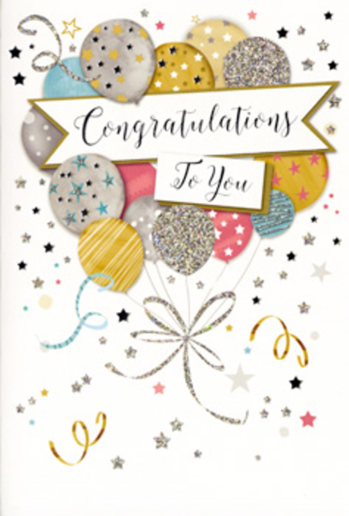 The photograph captures a sophisticated congratulations card whose festive design could easily accompany a thoughtfully arranged bouquet delivered anywhere in Byfleet. The card is shown upright, with its front illustration taking centre stage: a cluster of celebratory balloons gathered into a loose, airy composition that rises from the lower portion of the card toward the top. Each balloon is round and slightly overlapping its neighbours, creating a sense of fullness and gentle movement. The colour palette is soft yet celebratory, featuring shades of shimmering gold, pearly silver, champagne beige, pastel blue, blush pink, and misty grey. Surface patterns of tiny stars, fine stripes, and glitter-like textures are scattered across the balloons, giving them a light metallic sheen that evokes party décor without overwhelming the eye. Through this cluster winds an elegant banner, stretching across the middle and bearing the words Congratulations To You in stylish, flowing script. The lettering appears slightly raised, reminiscent of quality card finishes you'd expect from a premium greeting chosen for an important milestone. Encircling the balloons are slender, curling ribbons and a sprinkling of golden and silvery stars that drift against the pale background like confetti in slow motion. The composition is carefully balanced, with ample light space around the central design so the colours and metallic elements stand out clearly. The mood of the card is joyful, proud, and sophisticated, ideal for celebrating exam successes, new careers, promotions, or other life achievements, and perfectly suited to be delivered with flowers across Byfleet's homes and workplaces.