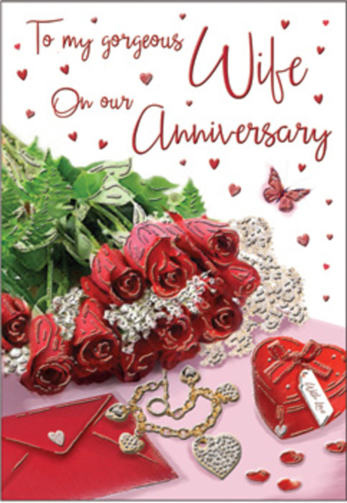 A richly detailed anniversary tableau unfolds in this image, evoking the quiet elegance of a special evening celebrated in Byfleet. At its centre lies a bouquet of classic red roses, each flower luxuriously full, as though at the perfect stage of bloom. The petals are a deep, saturated crimson, their velvety surfaces catching gentle highlights that reveal their layered curls and delicate edges. Around the roses, lush green foliage winds and nestles, adding texture and depth, much like a hand-tied bouquet made ready for a doorstep surprise. The flowers are presented against a tasteful surface where subtle reflections emphasise the richness of the colour palette. Surrounding the central bouquet are symbolic objects-a jewellery set that glints discreetly, a vivid red box suggestive of a cherished gift, and delicate lace-like details that soften the overall look. Small heart motifs are scattered throughout, their varied sizes and finishes creating a playful yet romantic rhythm across the design. The scripted message on the card curves gracefully against this backdrop, its flourishes adding a sense of movement and intimacy even though the words themselves remain indistinct. Soft, warm lighting washes over the entire arrangement, flattering the reds and golds while lending the greens a gentle glow, similar to evening light slipping through a Byfleet window. Textures of velvet, satin, metal, and paper all coexist in harmony, inviting the imagination to linger on how they might feel to the touch. The composition conveys enduring affection and the comforts of long-term love, capturing the spirit of an anniversary moment shared quietly at home.