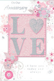 This softly romantic anniversary card is a gentle celebration of enduring love, much like a pastel bouquet arriving at a Byfleet doorstep. The central focus is the word LOVE, rendered in raised, velvety glitter that gives each letter a touch of dimension and shimmer. The O is replaced by a delicate silver heart, textured with a subtle sparkle that suggests something precious and carefully kept. Surrounding this focal point, a halo of blush and mauve blossoms unfurl with an almost watercolour softness, their petals blending into the soft pink background as if washed by light rain over a spring garden. The floral design is composed of fine, flowing lines and graceful curves, suggesting both movement and care-like stems thoughtfully placed by a florist arranging an anniversary bouquet for delivery around Byfleet and the surrounding lanes. Small decorative touches-petals, curls, and tiny, faint butterflies-are scattered throughout, adding a whimsical sense of motion and charm without feeling busy. The card's palette of pastel pinks and silvery greys creates an atmosphere of intimacy and calm, evoking evenings spent together reminiscing over shared memories. Subtle silver accents trace the edges of certain petals and leaves, glimmering when tilted toward the light, reminiscent of the soft shine on fresh foliage in a Byfleet flower shop display. The romantic phrases On Our Anniversary and I love you today and always appear in flowing, understated script, perfectly in tune with the overall elegance of the design. The entire card feels like a tender, keepsake note of devotion-quiet, heartfelt, and full of the kind of love that deepens with time.